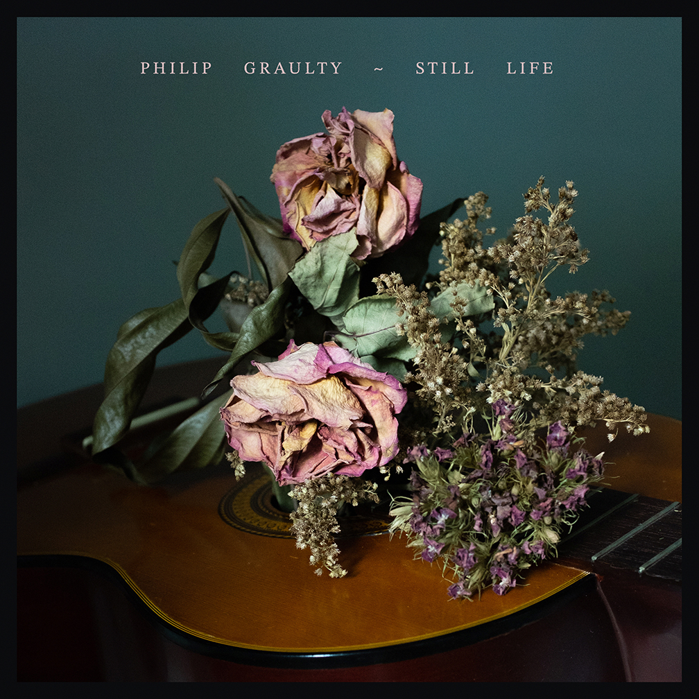 Decorative image. The cover art for Philip Graulty's album "Still Life." The image is a still photograph of a bouquet of flowers coming out of a classical guitar's sound hole.